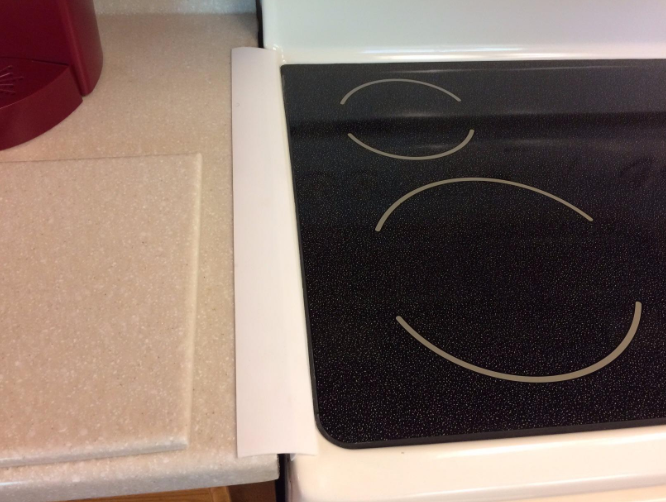 A reviewer's kitchen showing the gap between the counter and the oven covered with the product