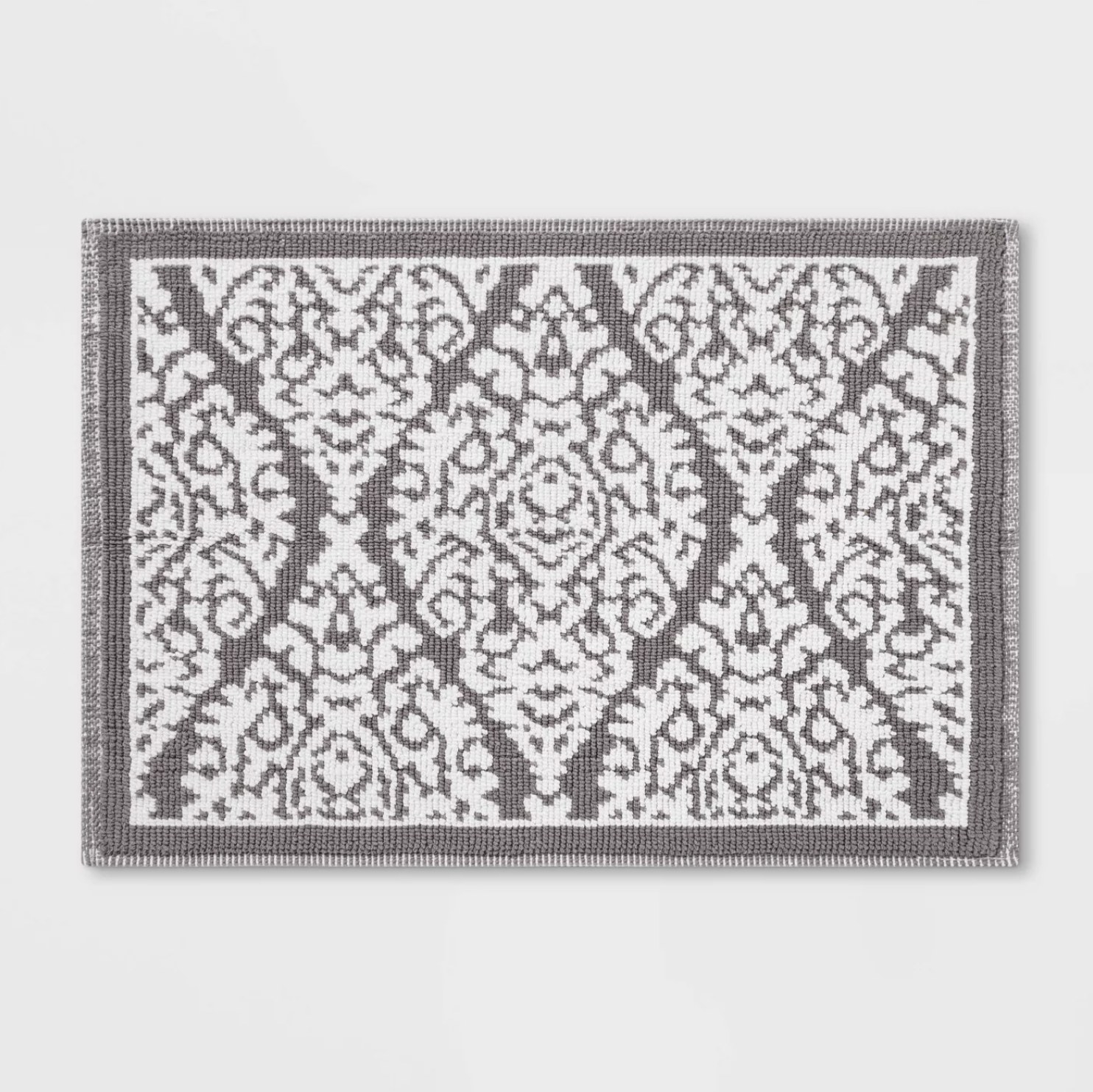 A gray and white patterned bath mat 