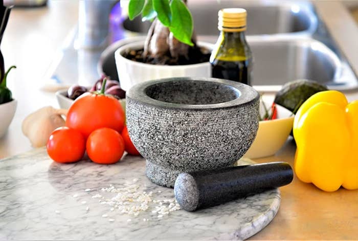 A table with the mortar and pestle surrounded by food items