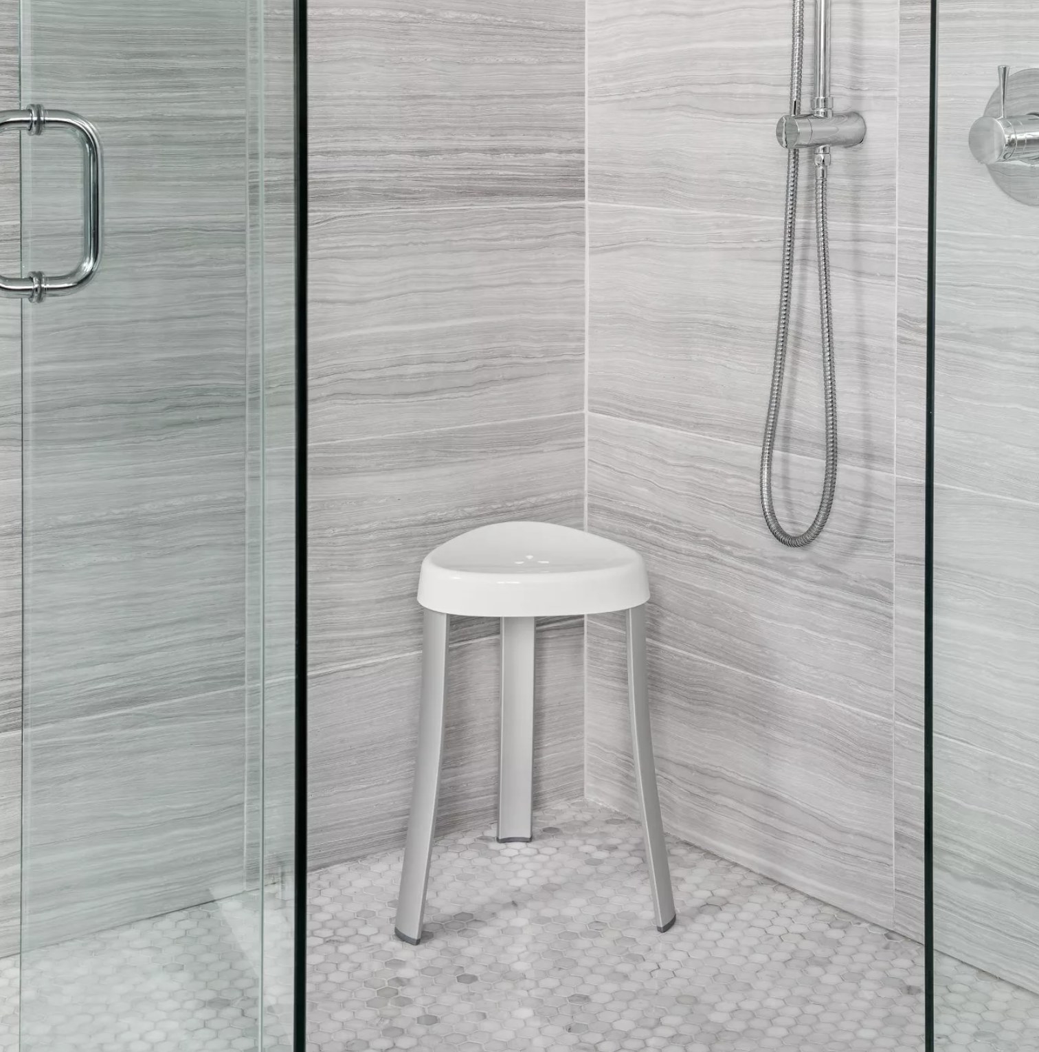 The white shower stool with three legs 