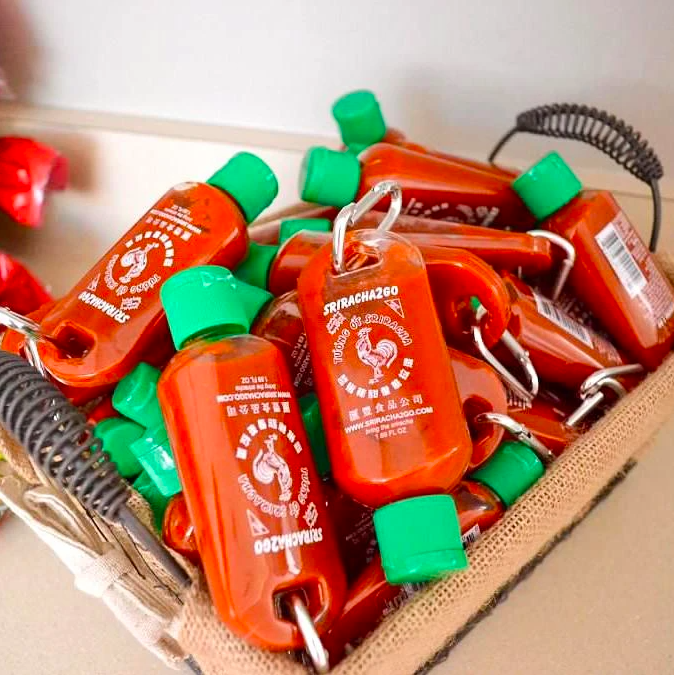 A basket filled with hot sauce keychains