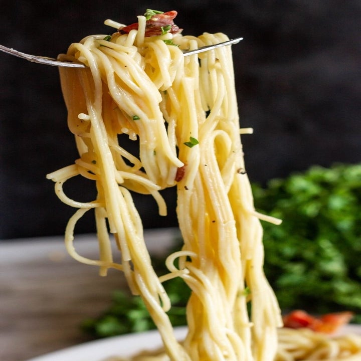 A fork-full of decadent spaghetti carbonara.