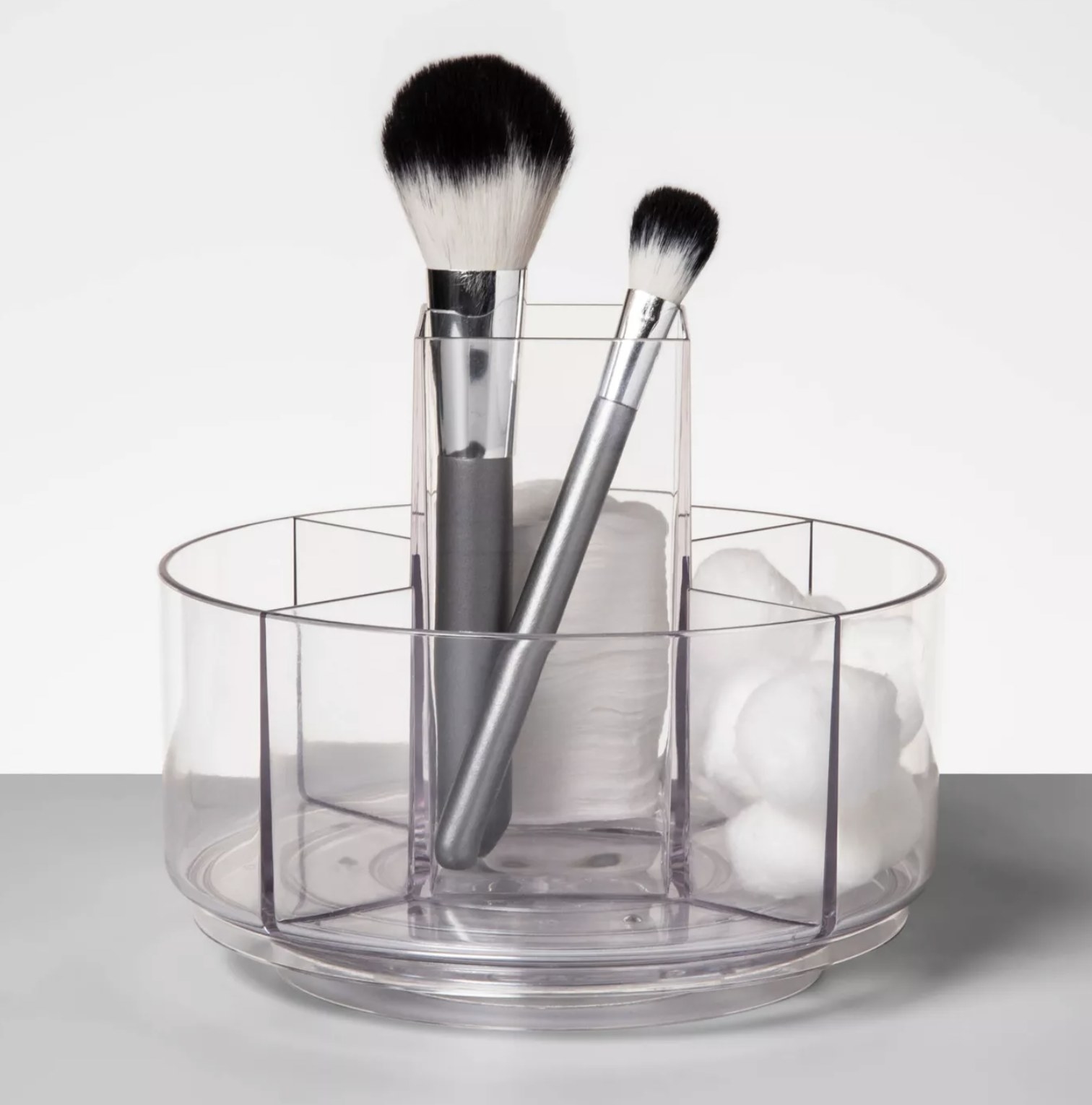 The translucent organizer with small sections for makeup tools 