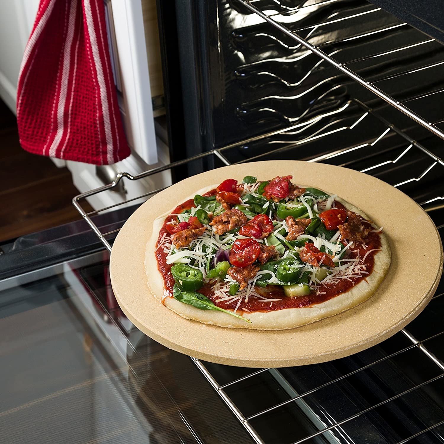 A pizza on the stone inside an oven on a rack