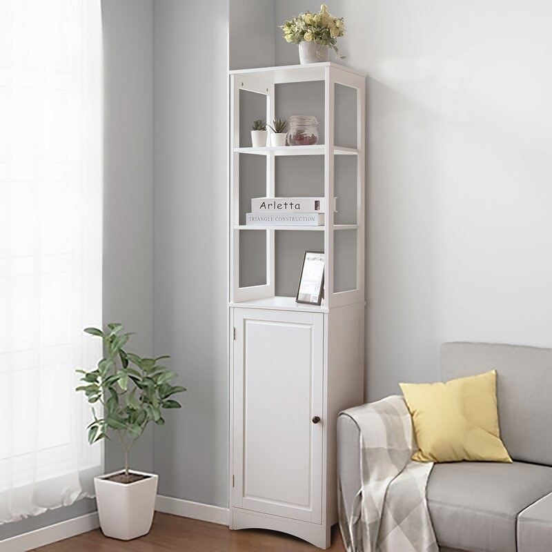 A linen cabinet with three open tiers at the top and a two additional shelves enclosed with a door at the bottom. It's white.