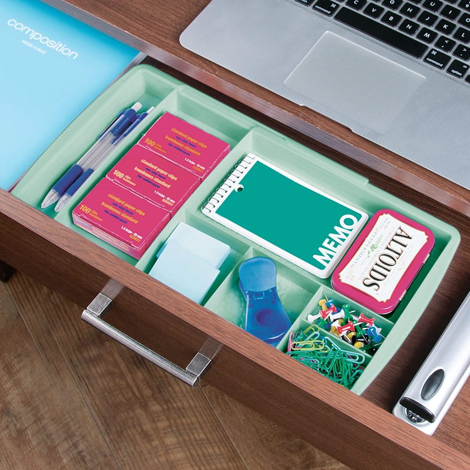 A desk organizer stocked with thumbtacks, paperclips, sticky notes, breath mints, and more