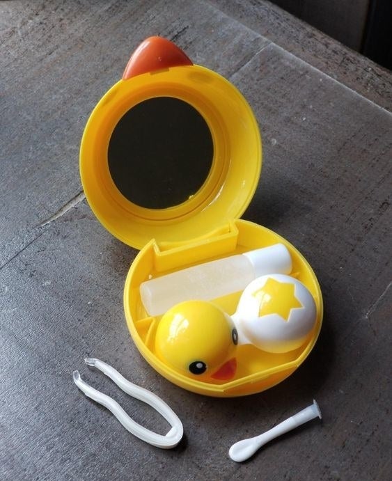 Reviewer's picture of the chick-themed contact lens travel case