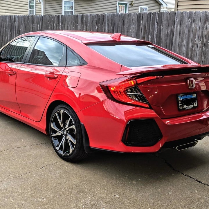 Reviewer photo of their car after which looks really shiny and basically brand new after using the buffer
