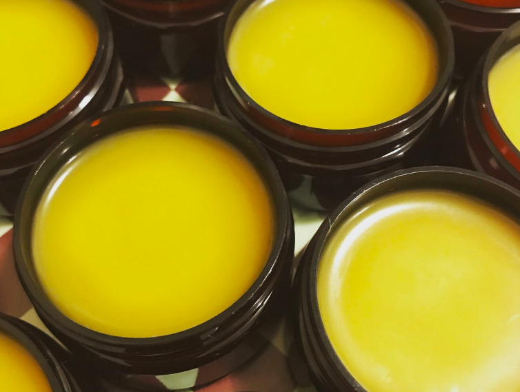 A closeup shot of the balms packaged in apothecary containers 