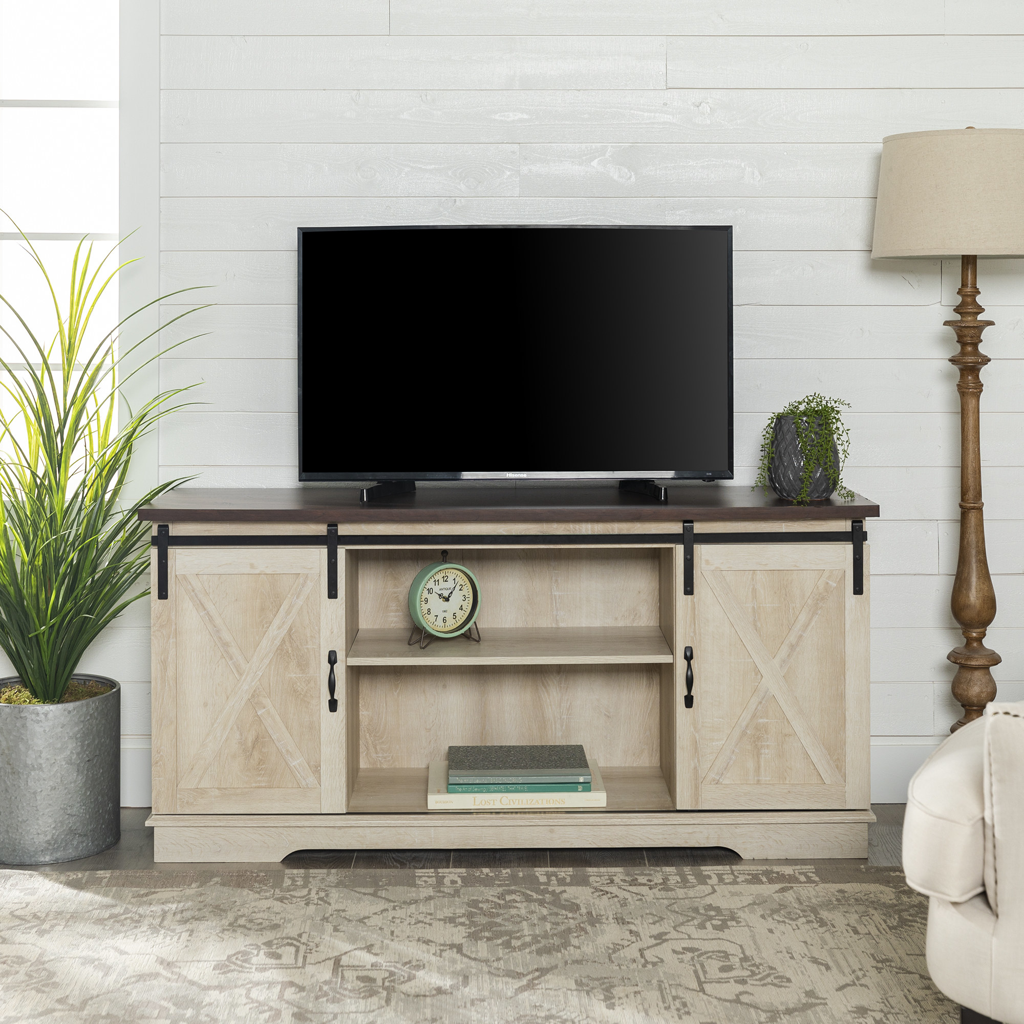 A brown and white oak televisions stand with two cabinets and shelf space in the middle