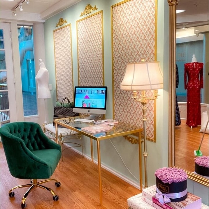 Emerald green version of the chair in an office from also decorated with other gold-accented furniture