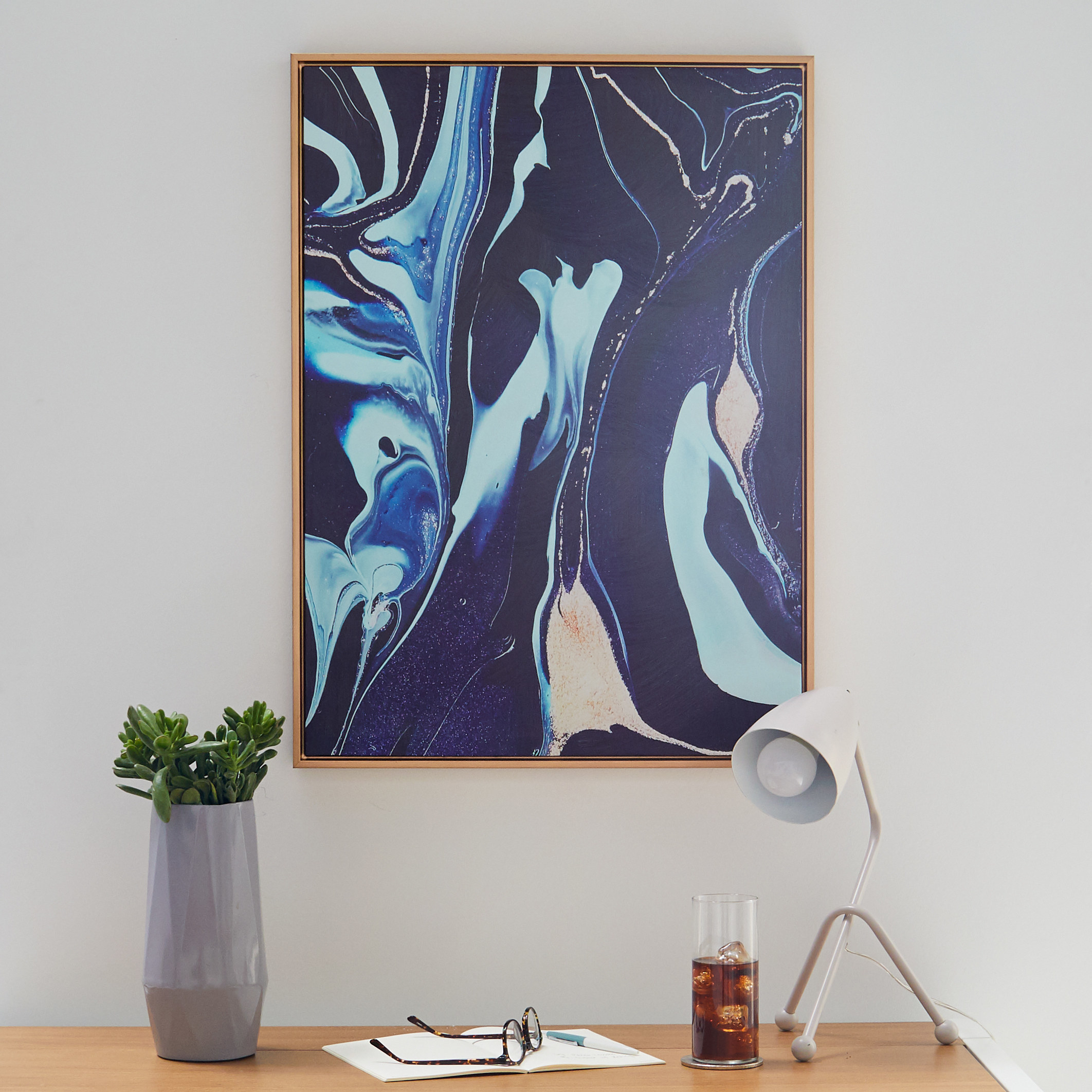 A framed print of a dark blue and light blue marble design