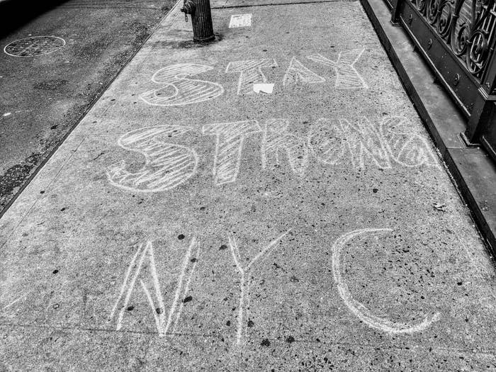 &quot;STAY STRONG NYC&quot; written in chalk on a sidewalk