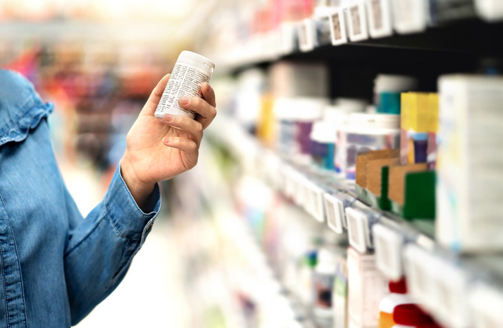 Person holding pills at the store.