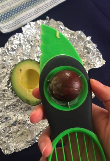 A reviewer photo of a pit removed from an avocado using the slicer