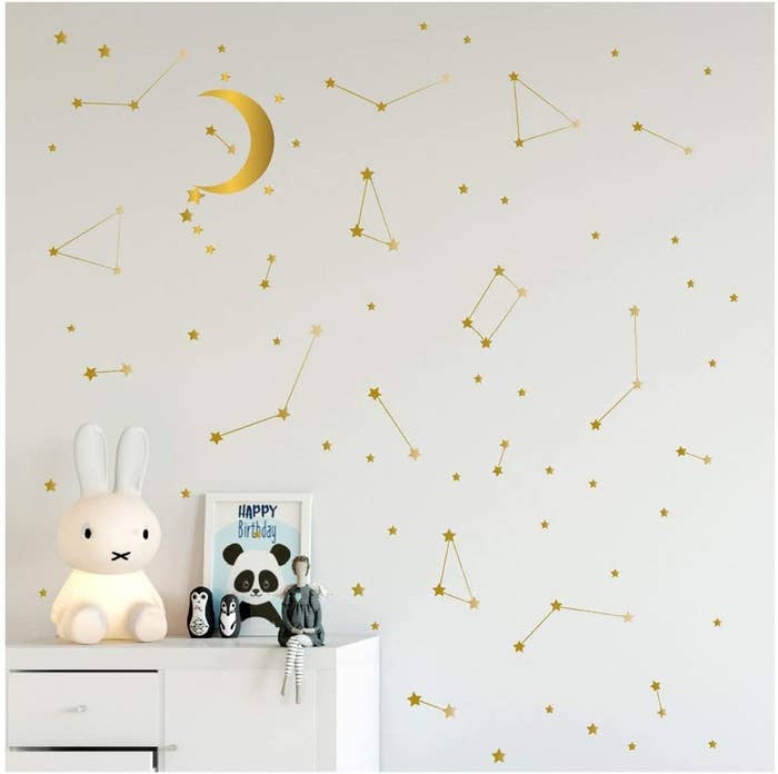 A wall covered in metallic star and constellation decals