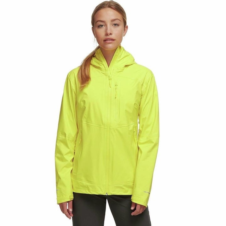 model in neon yellow hooded rain jacket