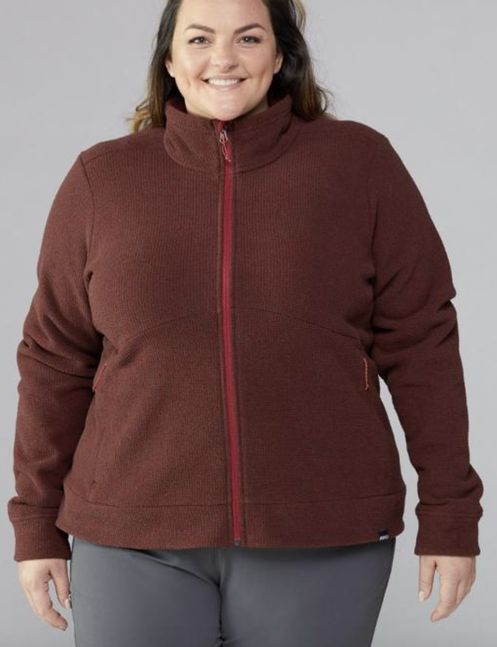 model in dark red zip-up fleece