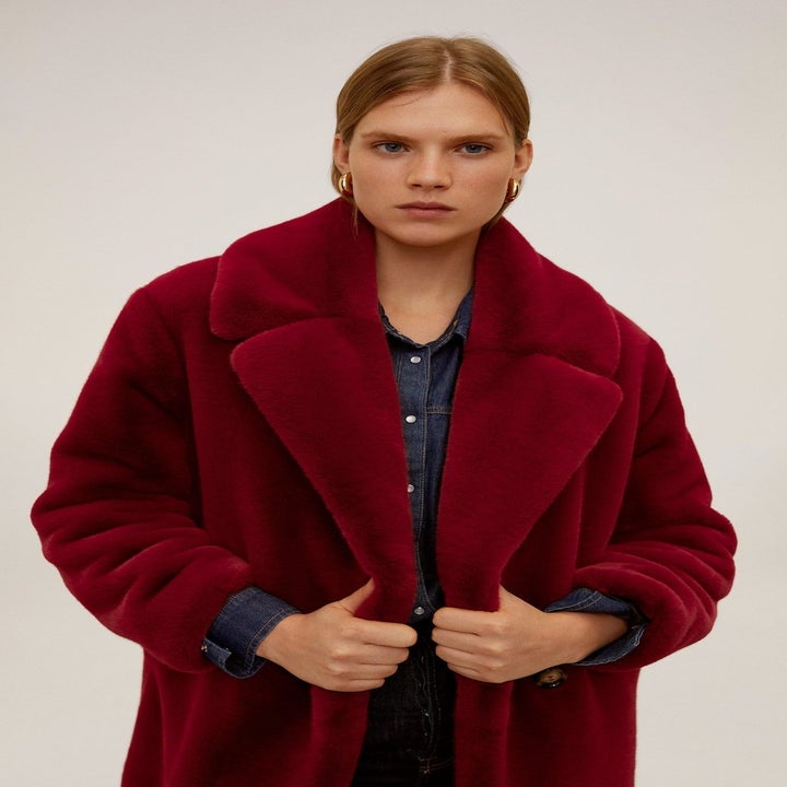 Model in a burgundy faux fur coat, available in women's sizes