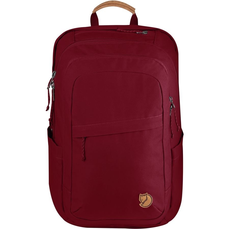 A red backpack with side pockets and two front pockets and a handle 