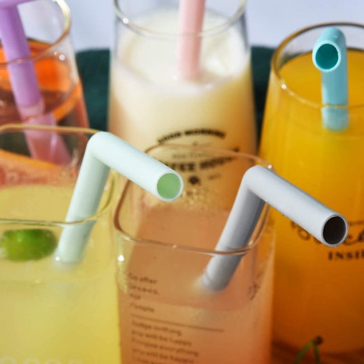 A close up of the bent straws in colourful cocktails