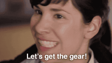gif of Carrie Brownstein in the tv show &quot;Portlandia&quot; grinning wildly and saying &quot;let&#x27;s get the gear&quot;