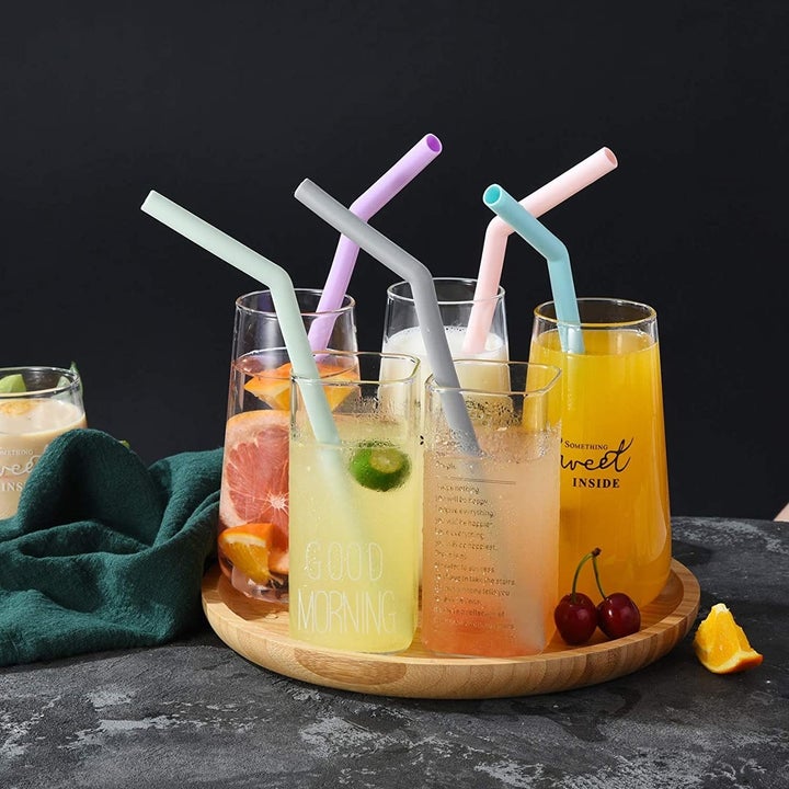 A tray of tropical cocktails with the straws inside