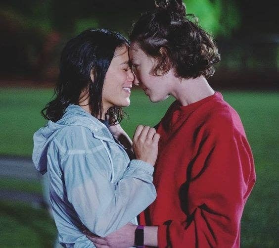 Izzie (left) and Casey (right) embrace each other during a kiss. 