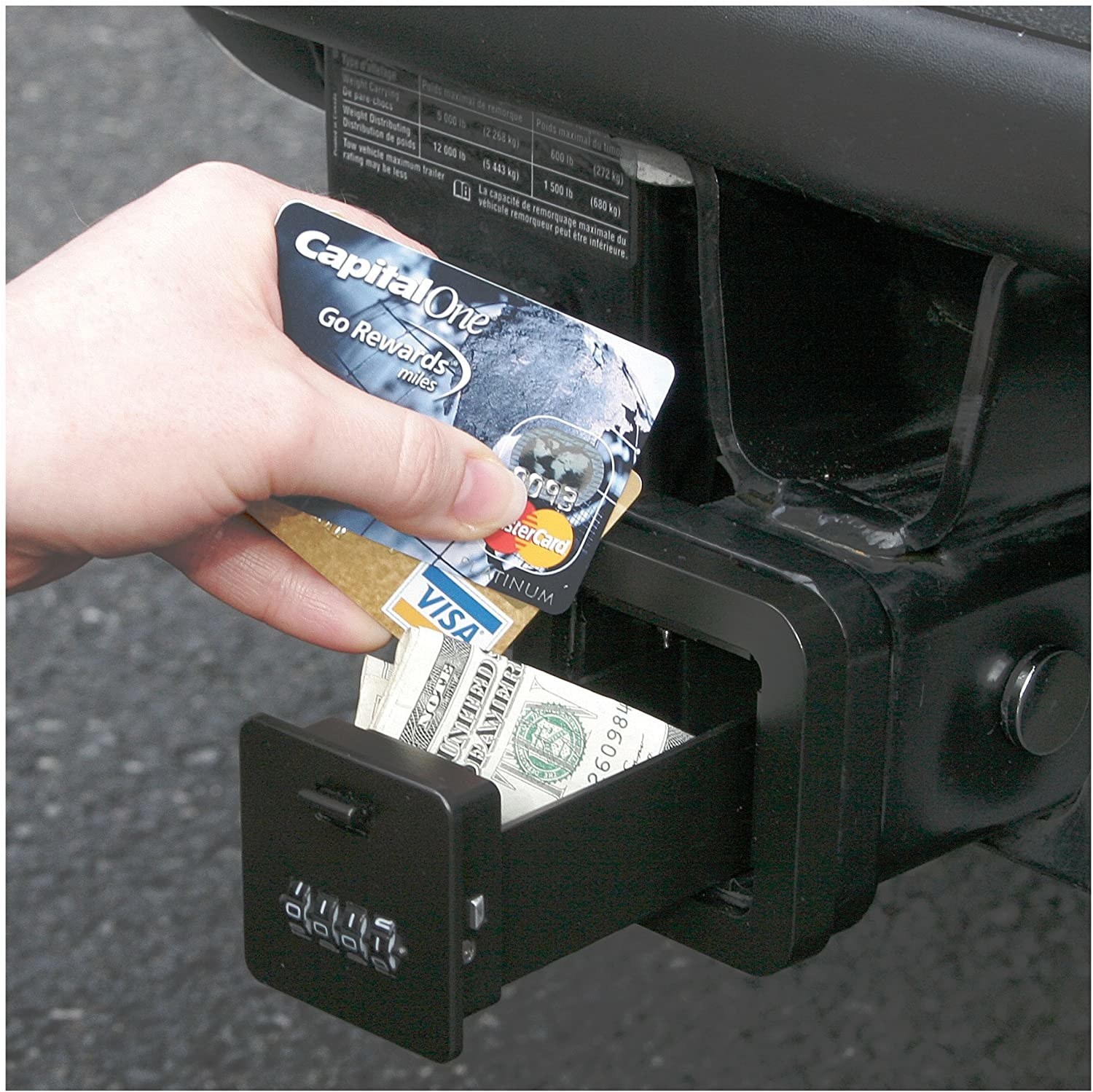 A person putting credit cards and money into their safe