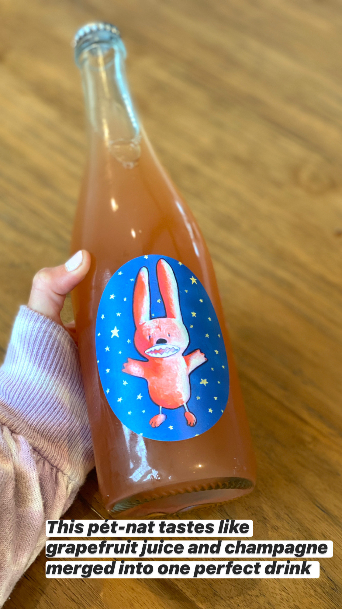 A bottle of peach-colored pét-nat wine with a bunny on its label.