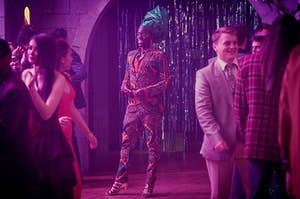 Eric Effiong from Sex Education wears a patterned suit and headwrap to the school dance. 