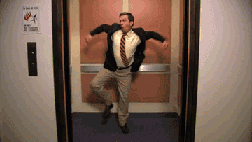 Gif of Andy Bernard dancing excitedly in an elevator 