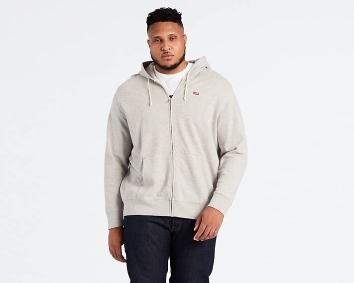 Model wearing the zip hoodie in gray 