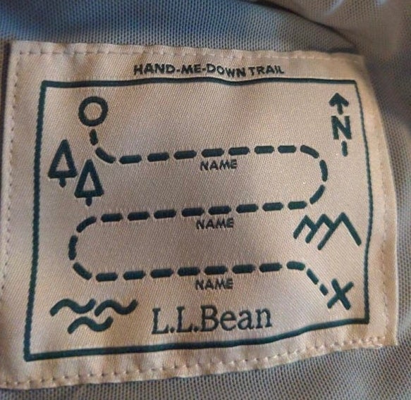 A jacket tag that has three lines for a name to be written on it