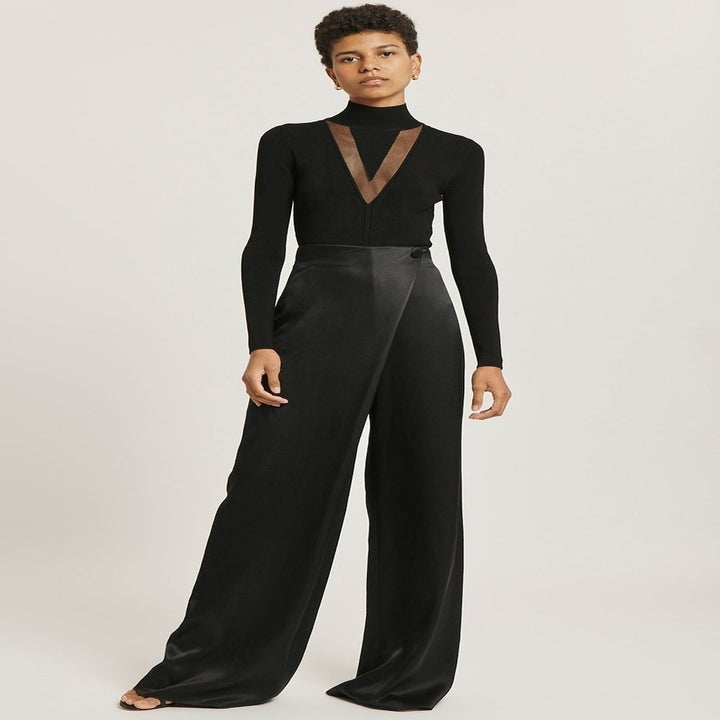 Model in a stretchy black turtleneck with sheer inset v-neck