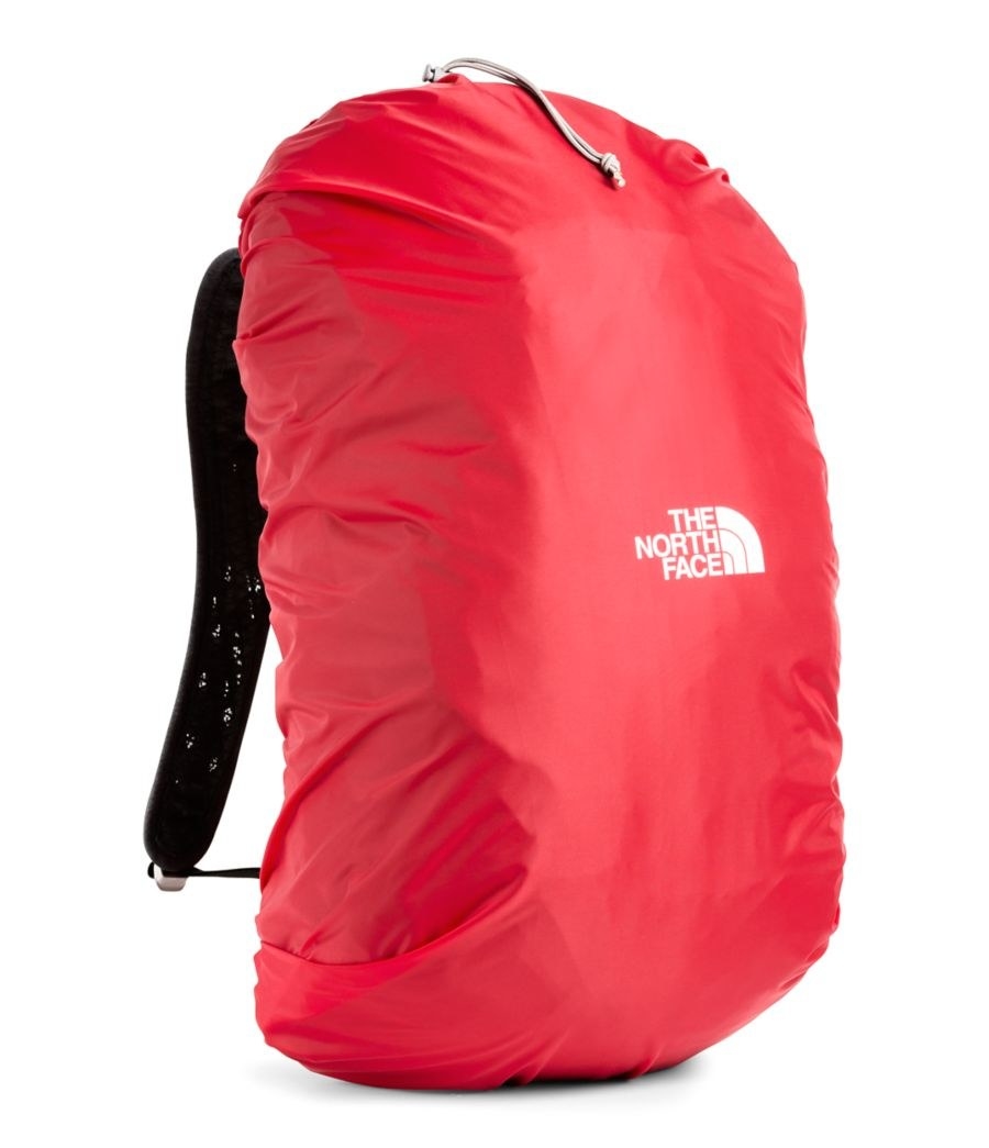red cover entirely over pack with a drawstring at the top that says &quot;the north face&quot;