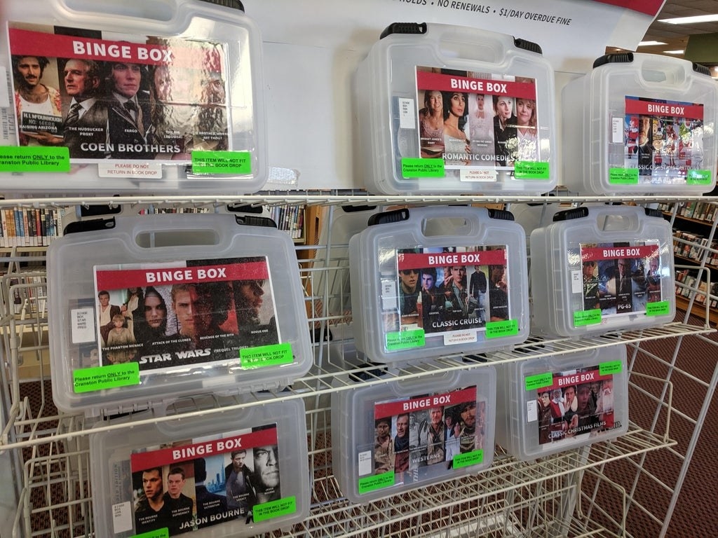 Plastic boxes holding several movies of the same genre 