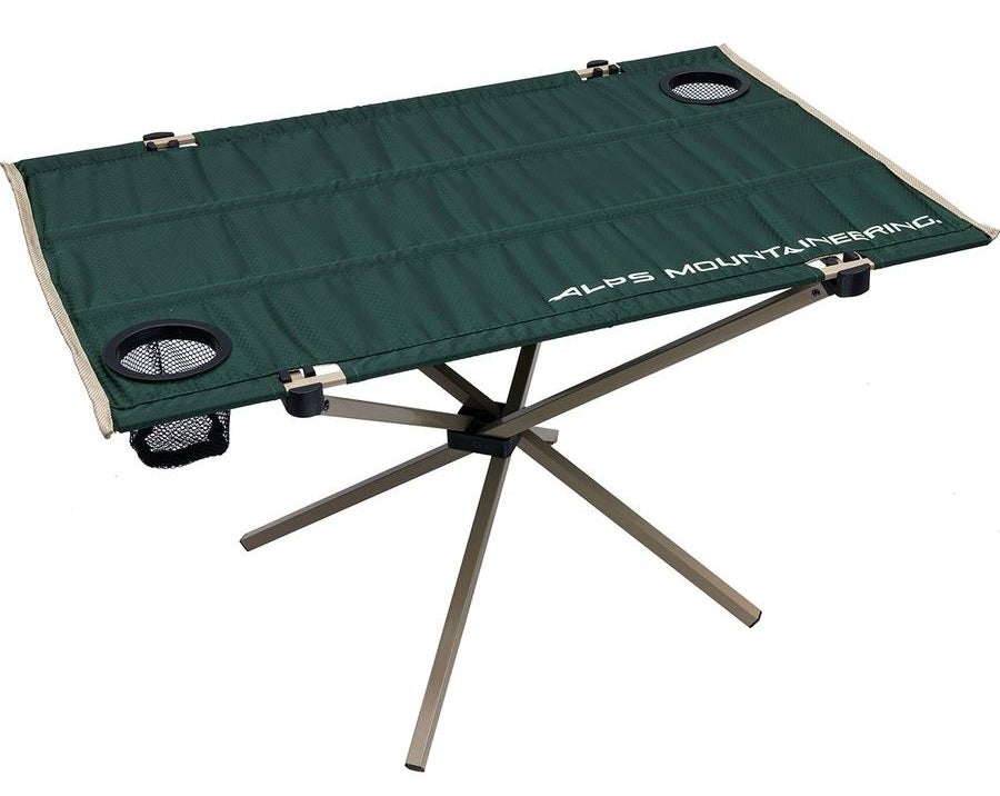 green cloth-top table with two cup holders