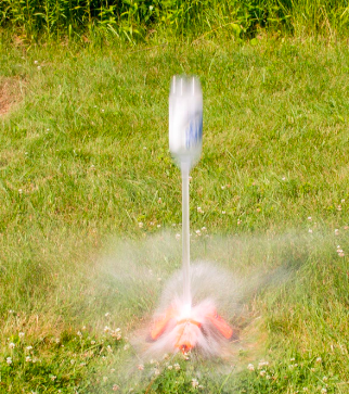 A review image of the launcher in action, shooting a water bottle in the air so fast it is blurry in the image