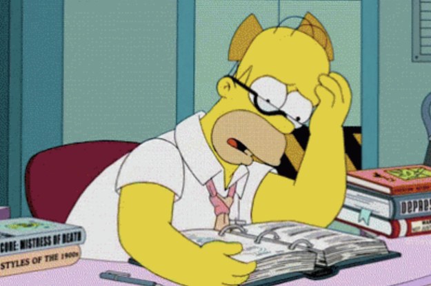 Homer Simpson looking concerned while he attempts to study a textbook