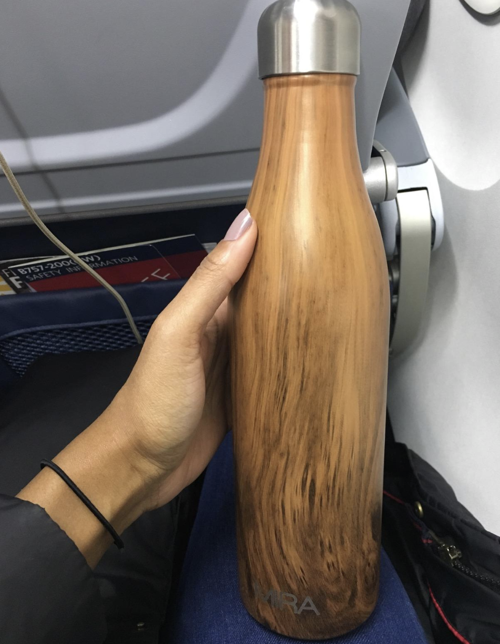 reviewer photo of wood-inspired water bottle with silver cap