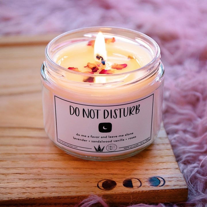 a glass candle that says "do not disturb" on it