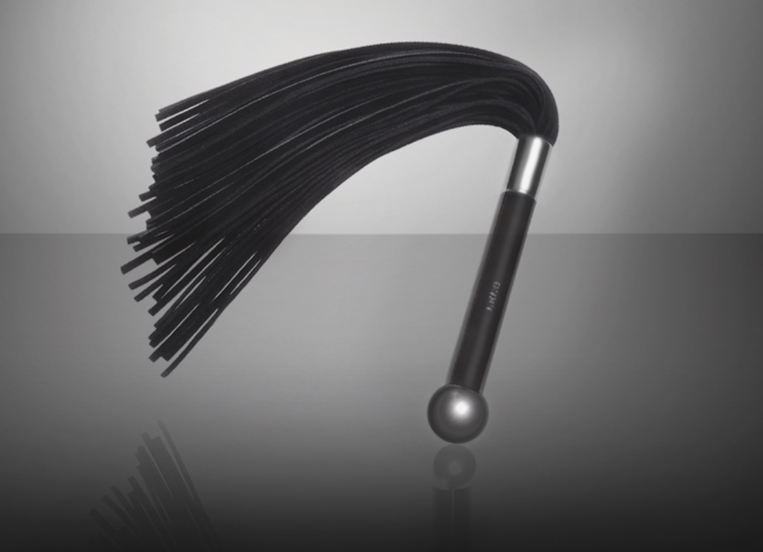 whip with a black and chrome handle and a fringe &#x27;whip&#x27; part
