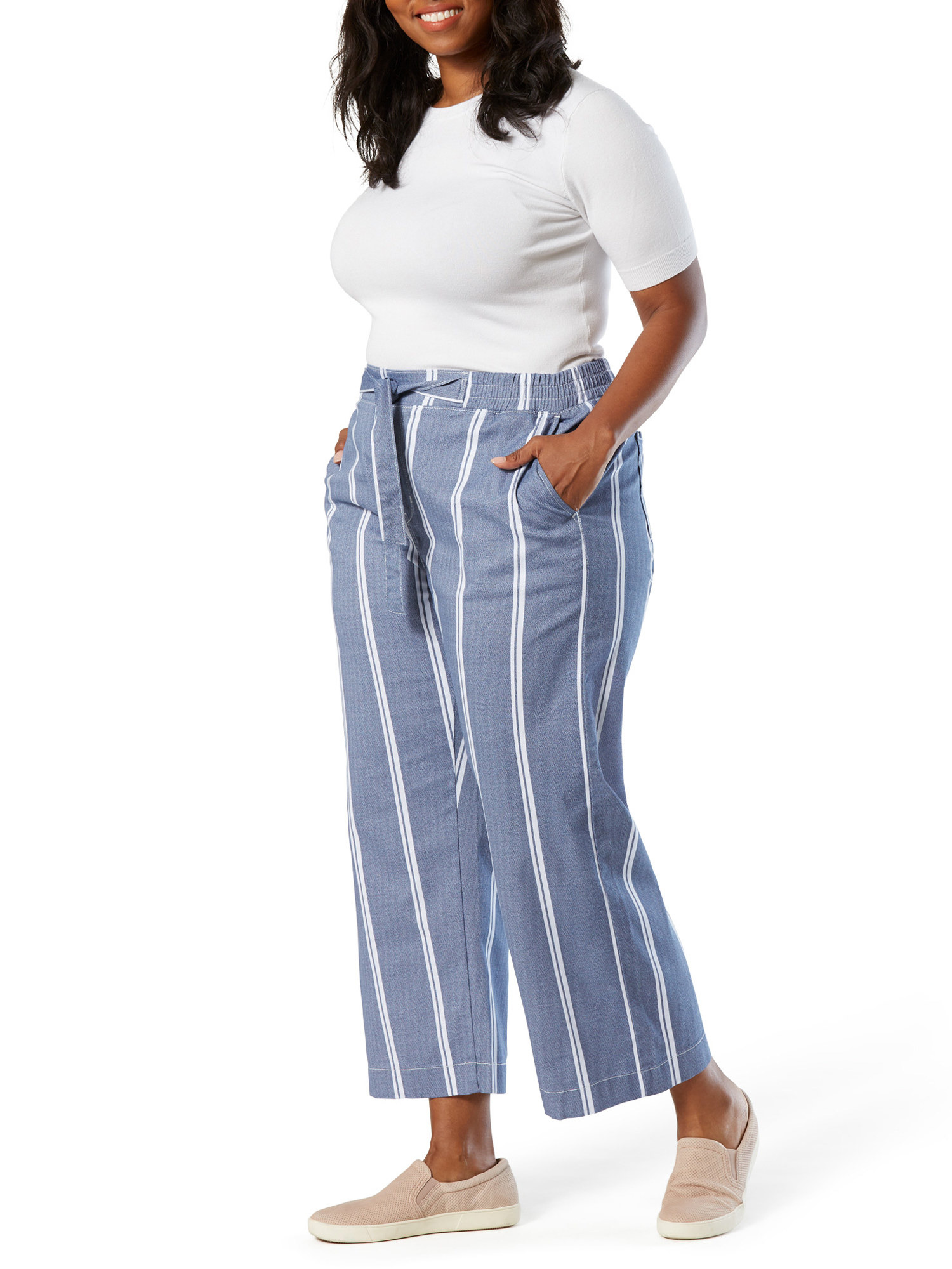 a model in blue linen pants with vertical white stripes