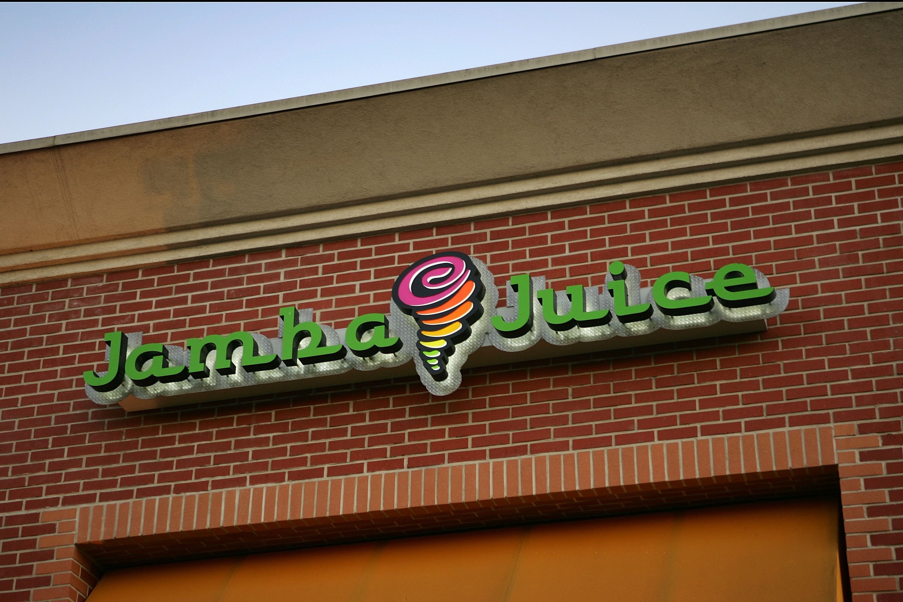 A close-up of the the Jamba Juice sign on a brick building.