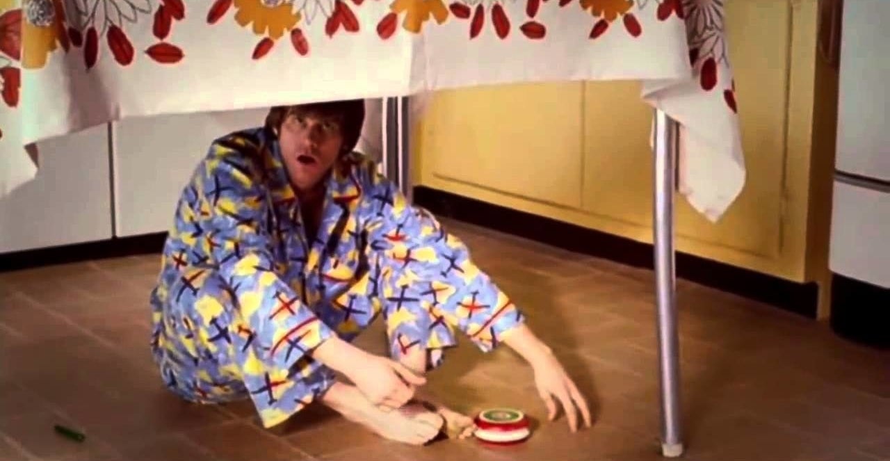 Grown up Joel in pajamas playing under a table.