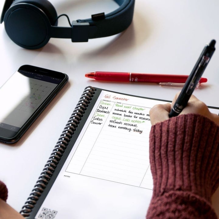 A person writing in their notebook