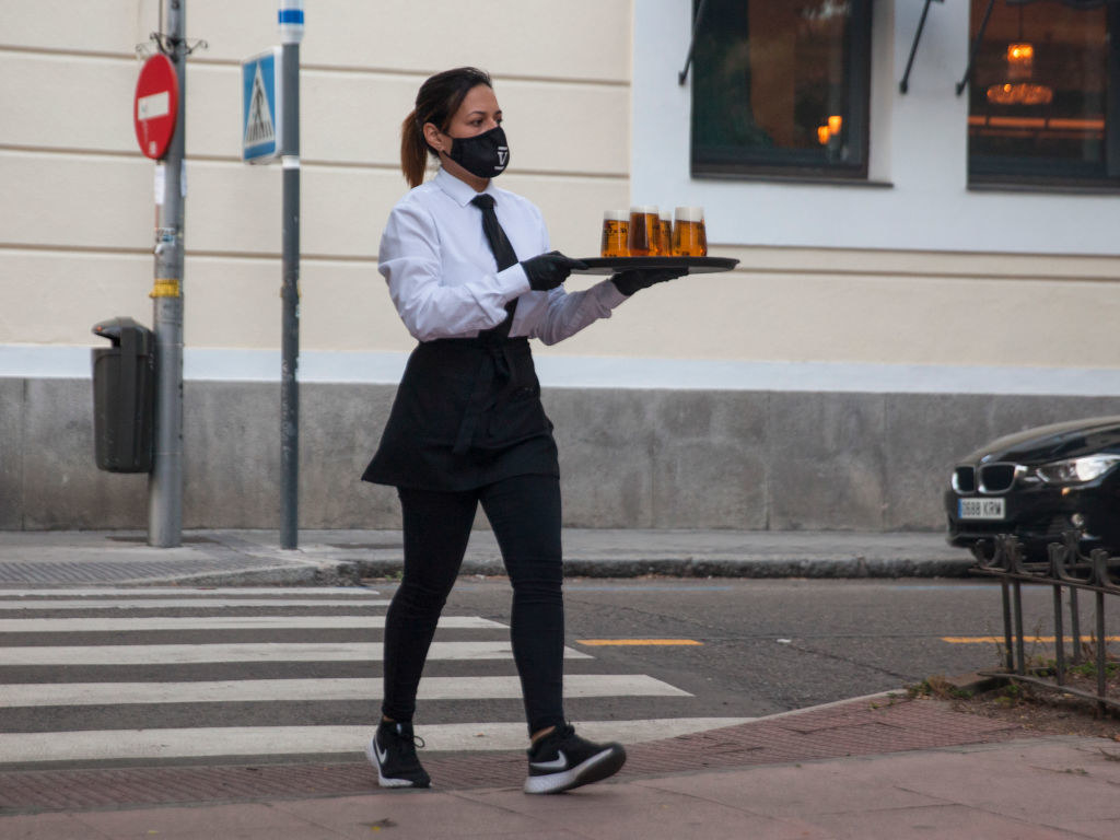 Server delivering drinks across the street