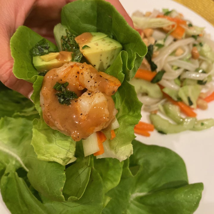 A close-up of a shrimp lettuce wrap with avocado.