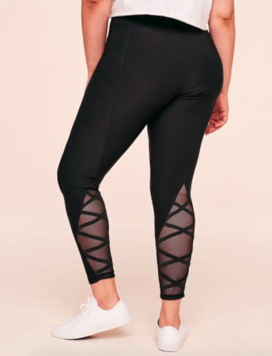 Model wears black leggings with mesh criss-cross detailing and fabric on the calves
